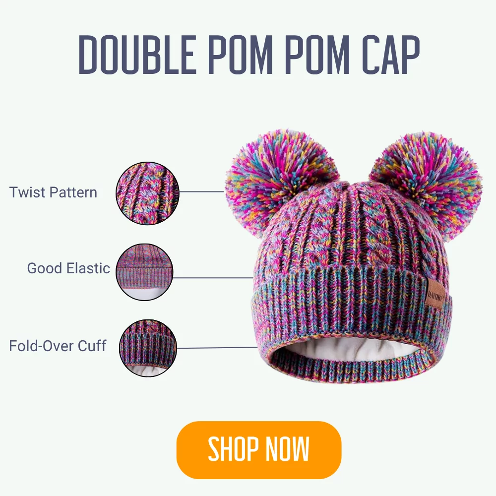 Double pom pom kids' beanie with twist pattern and fold-over cuff, perfect for a warm winter. Shop now!